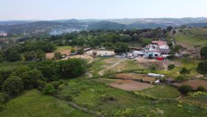 an aerial view of a farm with mountains in the background at MAVİ AT HOTEL Blue Horse in Gümüşdere