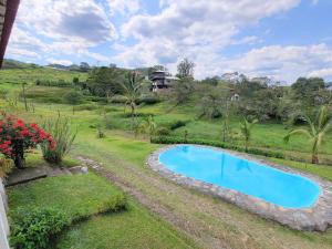 an overhead view of a swimming pool in a yard at Mountain view house in Sasaima