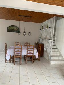 ein Esszimmer mit einem Tisch, Stühlen und einer Treppe in der Unterkunft Ti kaz peruches in Saint-Pierre