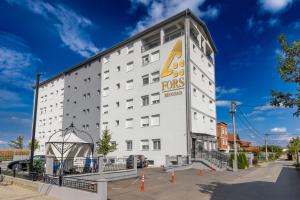 a white building with an eos hotel sign on it at ForS Resort & Spa in Belgrade