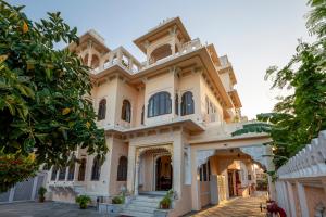 a large house with a building at Sterling Jaisinghgarh Udaipur in Udaipur