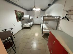 a room with two bunk beds and a table at Piata Uniri Cozy Inn in Bucharest