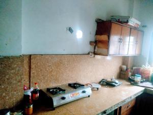 a kitchen with a stove and a counter top at Nomadic Hostel in Udaipur