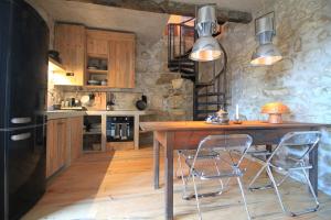 a kitchen with a wooden table and two chairs at Villa Cornelia, Ponte de Lima in Ponte de Lima