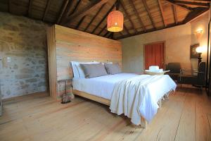 a bedroom with a large white bed in a room at Villa Cornelia, Ponte de Lima in Ponte de Lima