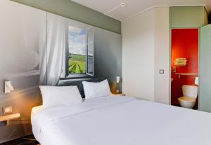 Letto o letti in una camera di B&B HOTEL Beaune Sud 2