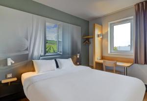 Letto o letti in una camera di B&B HOTEL Beaune Sud 2