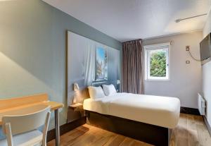 Letto o letti in una camera di B&B HOTEL Beaune Sud 2