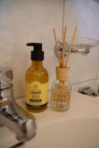 a bottle of lemon oil sitting on top of a sink at Chalet Terza in Quarten +7 photos