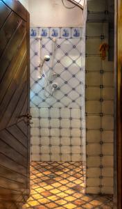 a bathroom with an open door with a shower at Casale il Pozzo in Sciacca +1 photo