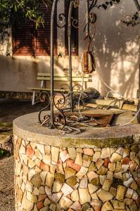 a stone table with a bench in the background at Casale il Pozzo in Sciacca