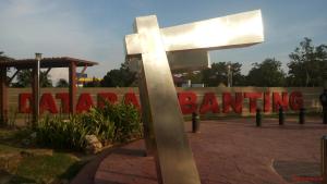 a large silver cross in front of a sign at ANGGUN HOMESTAY Banting in Banting