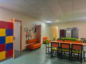 a classroom with tables and chairs in a room at Demeevsky Hostel in Kyiv