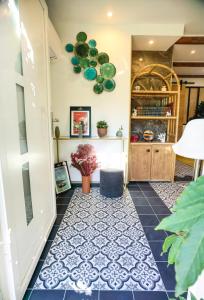 a hallway with a blue and white tile floor at Exquisite tiny house with garden and air con - between Paris-Disneyland - 3mins from train station in Noisy-le-Grand