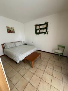 a bedroom with a bed and a chair in it at Casa Nonna Elide 2 in Besozzo