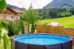 Niederuntersberg的住宿－Haus Unterrain，一个带围栏的院子内的一个大型游泳池