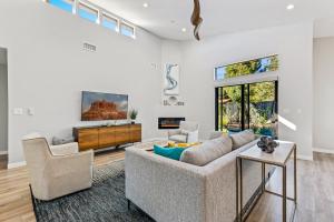 a living room with a couch and a tv at Modern Luxury Home in the Heart of West Sedona in Sedona