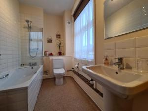 a bathroom with a sink and a toilet and a tub at 10to12 Folkestone in Folkestone