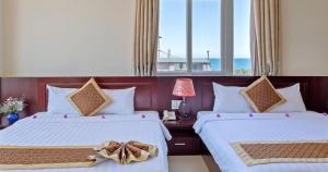 Ένα ή περισσότερα κρεβάτια σε δωμάτιο στο Sunview Beach Hotel Danang