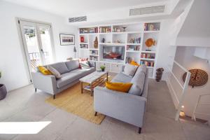 a living room with two couches and a tv at La Orza, Frigiliana Luxury center townhouse with pool and parking HansOnHoliday Rentals in Frigiliana