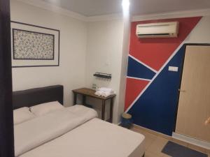 a small room with two beds and a small table at YSS Homestead Inderawasih in Perai