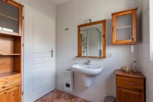 a bathroom with a sink and a mirror at Waterkant in Insel Poel