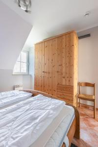 a bedroom with a large bed and a wooden cabinet at Waterkant in Insel Poel