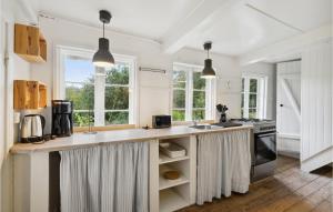 a kitchen with white walls and a large counter top at Cozy Home In Nstved With Kitchen in Næstved