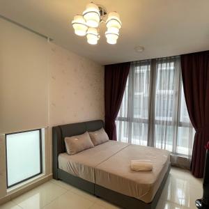 a bedroom with a bed and a large window at H2O Residences Ara Damansara PJ with WiFi Washing Machine and Dryer in Petaling Jaya