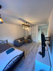 a living room with a bed and a couch at Przy Moście in Rzeszów