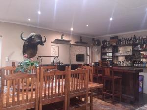 a restaurant with a bull head on the wall at Leadwood Lodge in Tzaneen