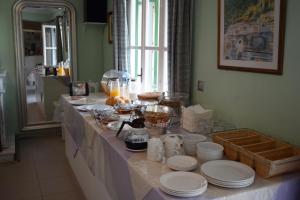 a table with plates and dishes on it in a kitchen at Stella Hotel Apartments in Fiskardo