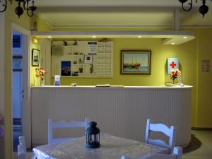 a restaurant with a counter with a table and chairs at Stella Hotel Apartments in Fiskardo