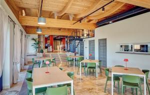 a dining room with tables and chairs and wooden ceilings at Poggio Santa Maria in Badia