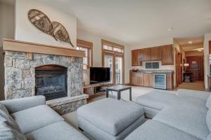 a living room with couches and a fireplace at Lone Eagle Ski In Ski Out Condo in Dillon