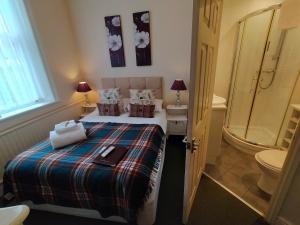 a bedroom with a bed and a shower and a toilet at Arden House in Harrogate +171 photos