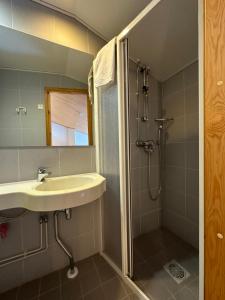 a bathroom with a sink and a shower at HolySuites 2 - Ski-in and out apartment in the middle of ski slopes in Pyhä in Pyhätunturi +22 photos