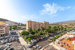 a city with cars parked in a parking lot at Valdes Center Los Cristianos in Los Cristianos