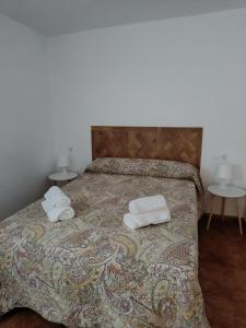 a bedroom with a bed with two towels on it at San Acacio 22 in Ronda