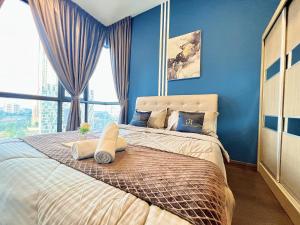 a bedroom with a large bed with blue walls and a window at SKS Pavillion Residence romantic luxury unit JBCC Netflix YouTube in Johor Bahru
