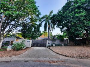 a driveway in front of a house with trees at Leadwood Lodge in Tzaneen