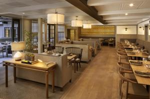 a dining room with tables and chairs and a restaurant at The Landsby in Solvang