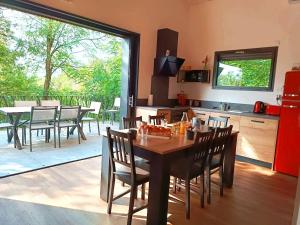 a kitchen and dining room with a table and chairs at Gîte la Chevêche in Treize-Vents