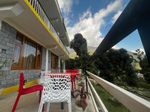 a table and chairs on the balcony of a house at Winterstone studio in McLeod Ganj +3 photos