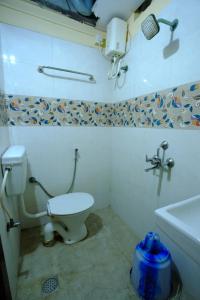 a bathroom with a toilet and a sink at Bava Inn in Chennai