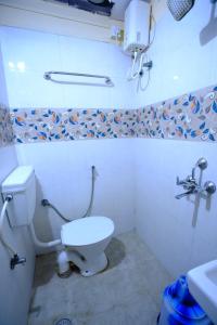 a bathroom with a toilet and a sink at Bava Inn in Chennai