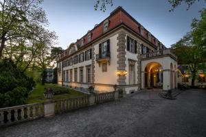 a large white building with a fence in front of it at Schlosshotel Berlin by Patrick Hellmann in Berlin