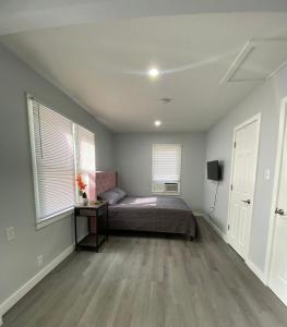 a bedroom with a bed and two windows at The Oasis in Sanford