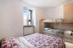 a bedroom with a bed and a bunk bed at Colico Center in Colico