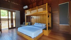 a bedroom with a bunk bed in a room at SMARANALA in Nusa Dua